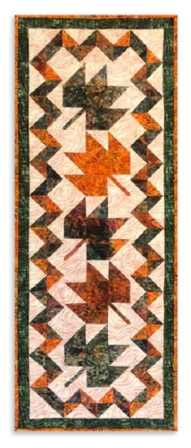 The finished Maple Leaf Table Runner by Donna Jordan displayed in a professional studio setting The finished Maple Leaf Table Runner by Donna Jordan displayed in a professional studio setting